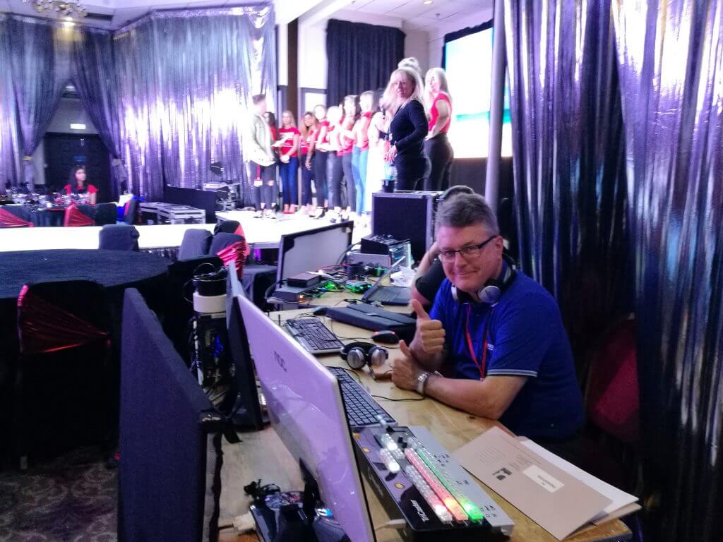 Photo of John managing the livestream desk at Miss England 2019